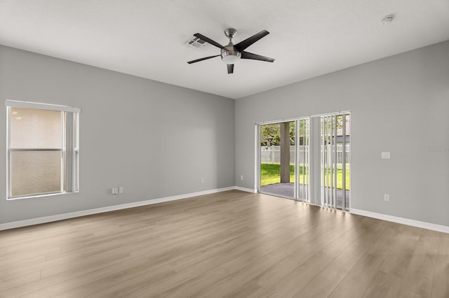 13658 Hidden Forest Cir, Orlando, FL 32828 - empty room featuring a ceiling fan, wood finished floors, and a smoke detector