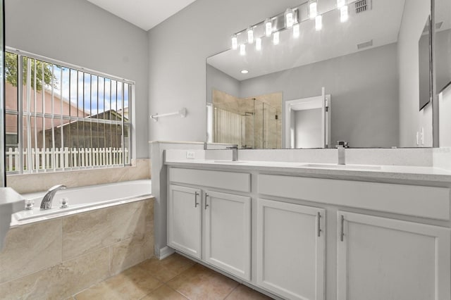 13658 Hidden Forest Cir, Orlando, FL 32828 - bathroom with double vanity, a stall shower, a bath, and tile patterned flooring