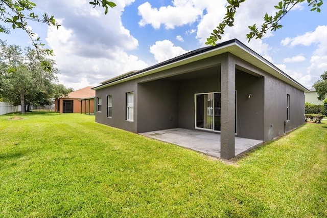 13658 Hidden Forest Cir, Orlando, FL 32828 - back of property featuring stucco siding, a patio area, and a lawn
