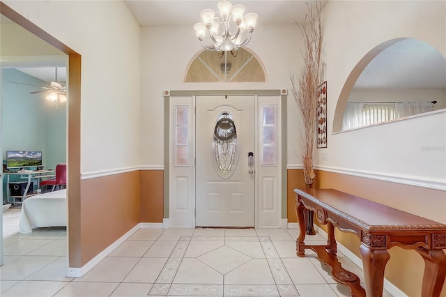 2800 Woodsmere Ct, Kissimmee, FL 34746 - foyer entrance featuring light tile patterned floors, a chandelier, ceiling fan, and arched walkways