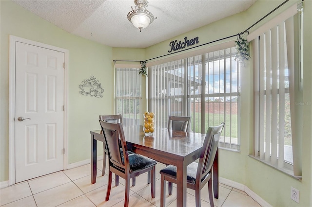 2800 Woodsmere Ct, Kissimmee, FL 34746 - dining area featuring healthy amount of natural light, a textured ceiling, and light tile patterned flooring