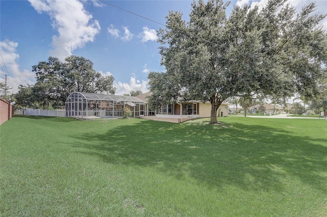 2800 Woodsmere Ct, Kissimmee, FL 34746 - view of green lawn with a patio and glass enclosure