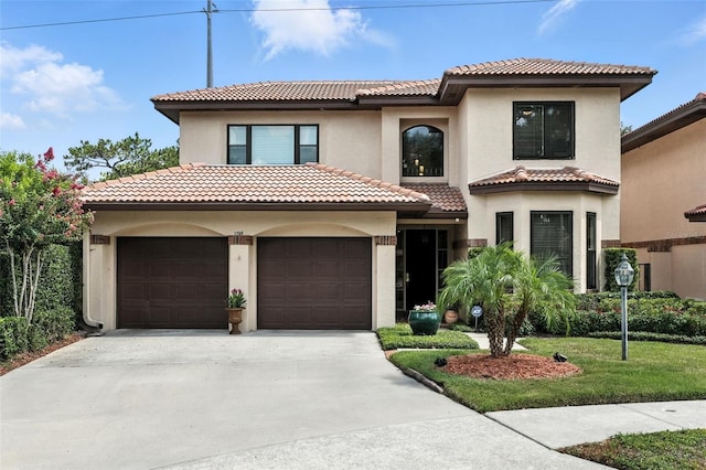 1769 Turnberry Ter, Orlando, FL 32804 - mediterranean / spanish home with concrete driveway, an attached garage, a tiled roof, and stucco siding