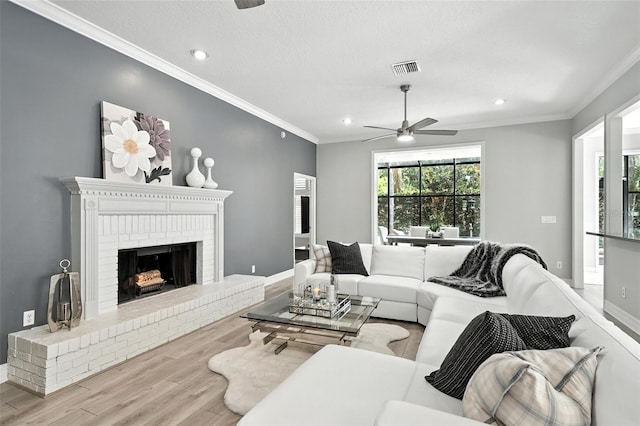 1769 Turnberry Ter, Orlando, FL 32804 - living area featuring ceiling fan, wood finished floors, crown molding, recessed lighting, and a brick fireplace