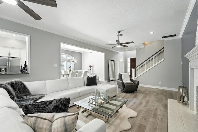 1769 Turnberry Ter, Orlando, FL 32804 - living area with a ceiling fan, light wood finished floors, recessed lighting, a textured ceiling, and crown molding