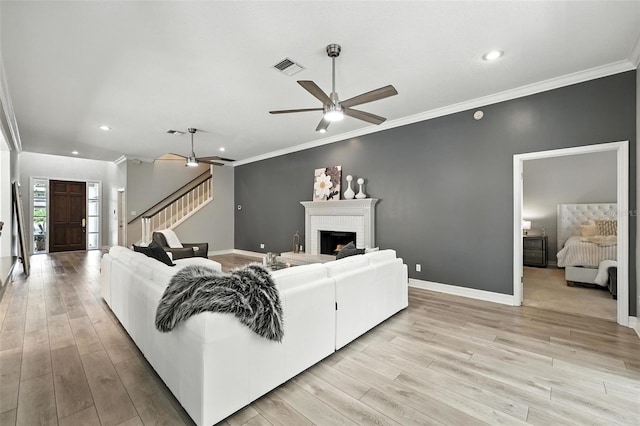 1769 Turnberry Ter, Orlando, FL 32804 - living area with stairs, a ceiling fan, light wood finished floors, a brick fireplace, and recessed lighting