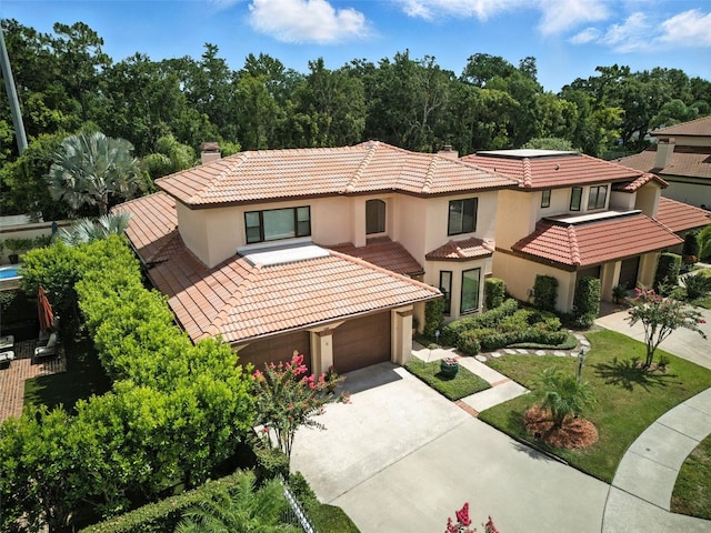 1769 Turnberry Ter, Orlando, FL 32804 - mediterranean / spanish-style house with stucco siding, a tile roof, driveway, and a chimney