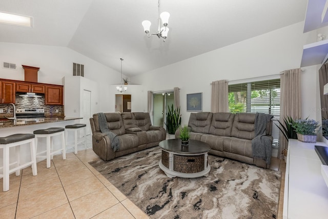 14301 Bending Branch Ct, Orlando, FL 32824 - living room with lofted ceiling, a chandelier, and light tile patterned floors