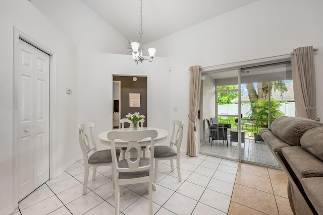 14301 Bending Branch Ct, Orlando, FL 32824 - dining area with a chandelier, light tile patterned floors, and vaulted ceiling
