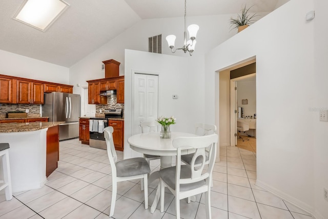 14301 Bending Branch Ct, Orlando, FL 32824 - dining area with a chandelier, light tile patterned flooring, and high vaulted ceiling