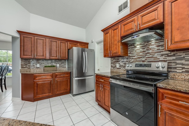 14301 Bending Branch Ct, Orlando, FL 32824 - kitchen featuring appliances with stainless steel finishes, premium range hood, lofted ceiling, light tile patterned floors, and backsplash