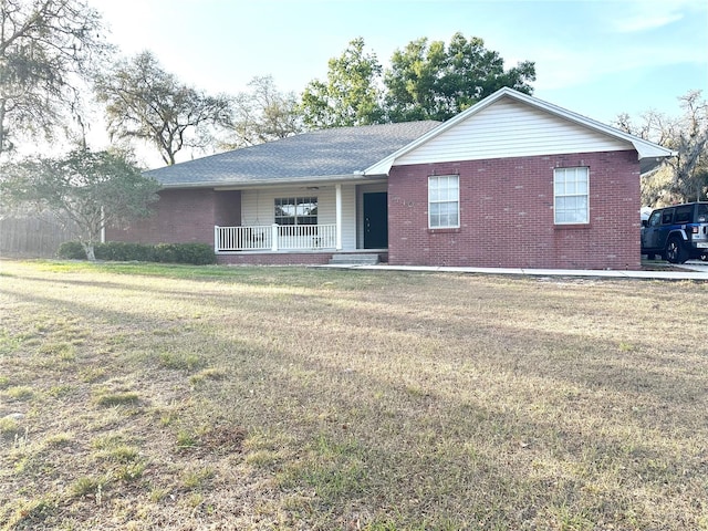 1140 Odoniel Loop S, Lakeland, FL 33809 - single story home featuring a porch, brick siding, and a front lawn