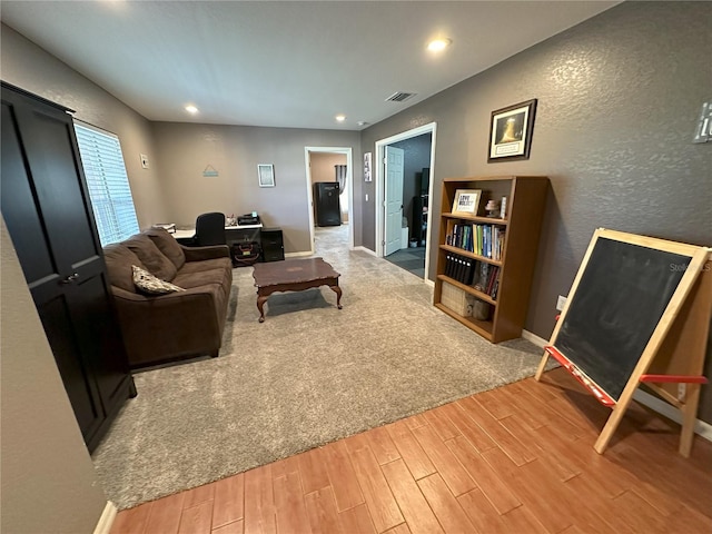 1140 Odoniel Loop S, Lakeland, FL 33809 - living room featuring wood finished floors, a textured wall, and recessed lighting