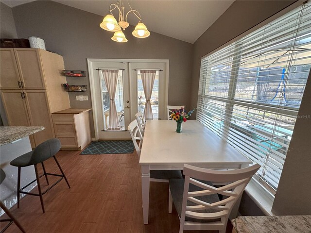 1140 Odoniel Loop S, Lakeland, FL 33809 - dining room with vaulted ceiling, dark wood-style flooring, a chandelier, and french doors