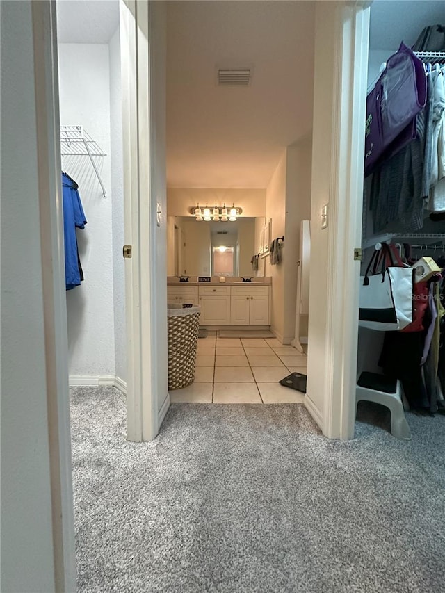 1140 Odoniel Loop S, Lakeland, FL 33809 - full bath featuring carpet floors, vanity, tile patterned floors, and a walk in closet