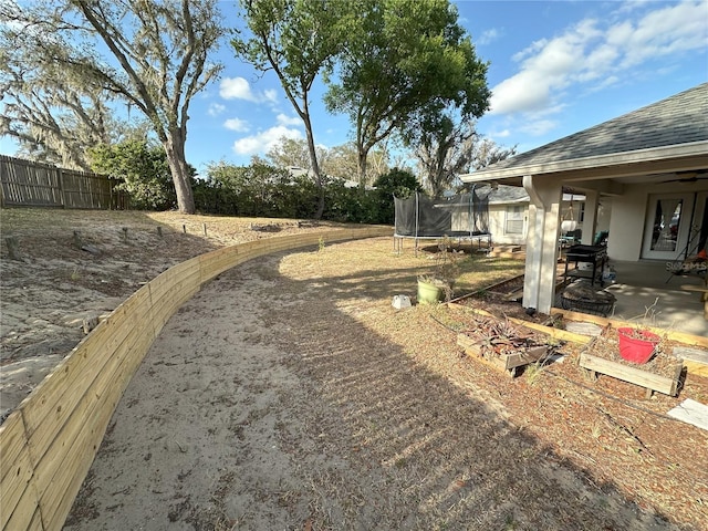 1140 Odoniel Loop S, Lakeland, FL 33809 - view of yard with a trampoline and a patio area