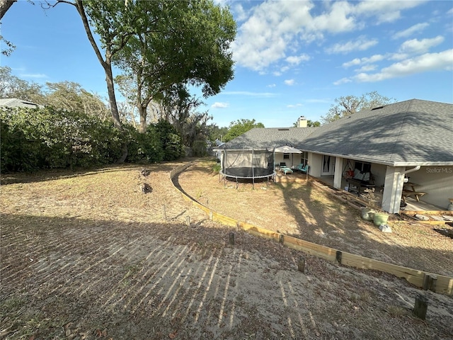 1140 Odoniel Loop S, Lakeland, FL 33809 - view of yard with a trampoline and a patio