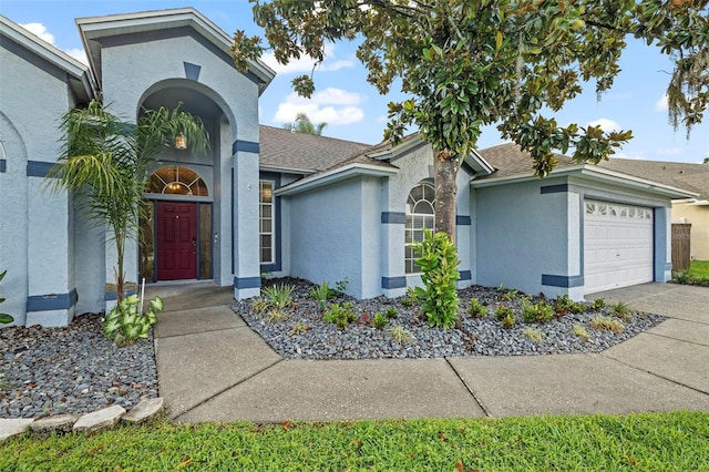 28707 Raleigh Pl, Wesley Chapel, FL 33545 - view of front of house featuring stucco siding, an attached garage, and driveway