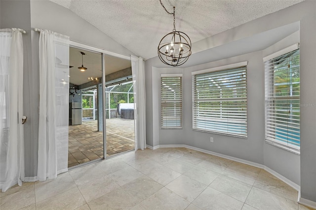 28707 Raleigh Pl, Wesley Chapel, FL 33545 - unfurnished room featuring a textured ceiling, a chandelier, lofted ceiling, and plenty of natural light