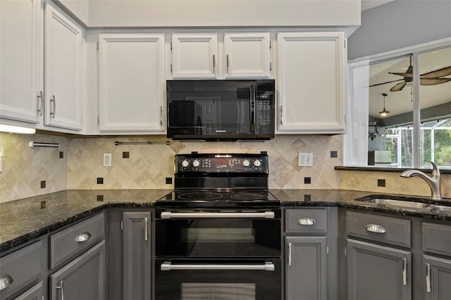 28707 Raleigh Pl, Wesley Chapel, FL 33545 - kitchen with black appliances, gray cabinetry, ceiling fan, dark stone countertops, and decorative backsplash