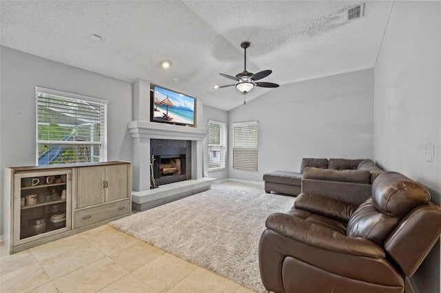 28707 Raleigh Pl, Wesley Chapel, FL 33545 - living area featuring ceiling fan, a textured ceiling, healthy amount of natural light, a fireplace with raised hearth, and vaulted ceiling