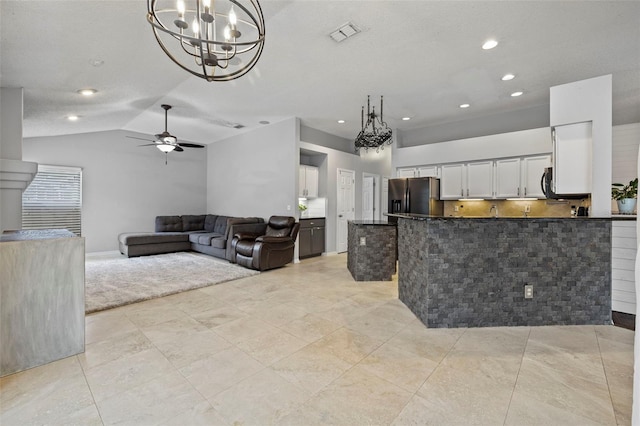 28707 Raleigh Pl, Wesley Chapel, FL 33545 - kitchen featuring stainless steel fridge, a chandelier, a peninsula, white cabinets, and a ceiling fan