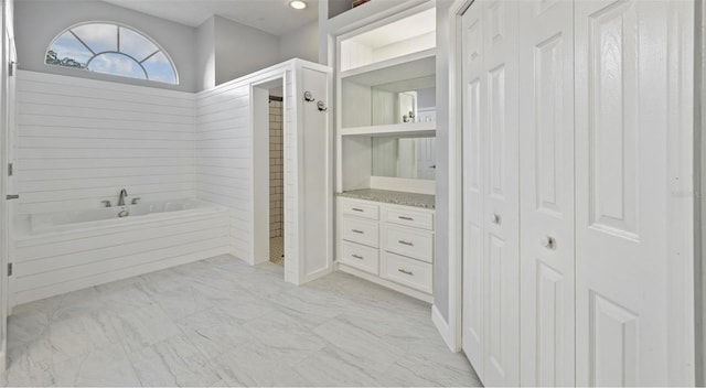 28707 Raleigh Pl, Wesley Chapel, FL 33545 - bathroom featuring a closet, a garden tub, and marble finish floors