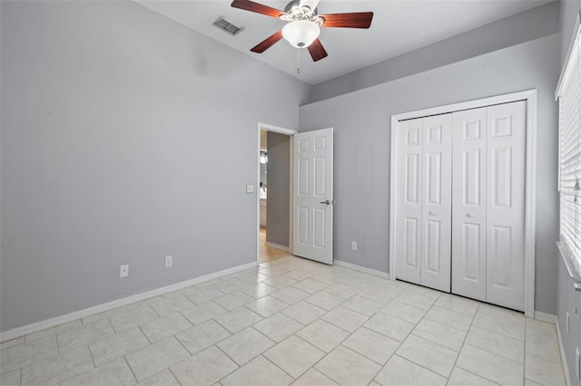 28707 Raleigh Pl, Wesley Chapel, FL 33545 - unfurnished bedroom featuring a closet, light tile patterned flooring, and a ceiling fan