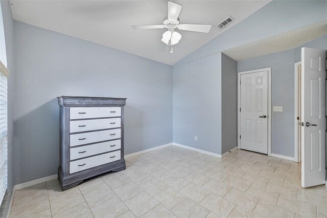 28707 Raleigh Pl, Wesley Chapel, FL 33545 - unfurnished bedroom with lofted ceiling, light tile patterned floors, and ceiling fan