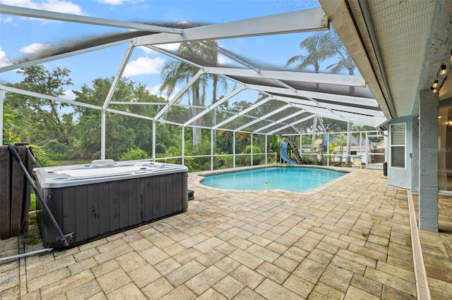 28707 Raleigh Pl, Wesley Chapel, FL 33545 - outdoor pool with a water slide, a hot tub, a patio area, and a lanai