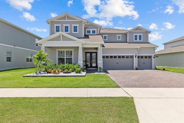 3179 Sailing Pier Ave, Winter Garden, FL 34787 - craftsman-style house with french doors, decorative driveway, an attached garage, a shingled roof, and a front yard