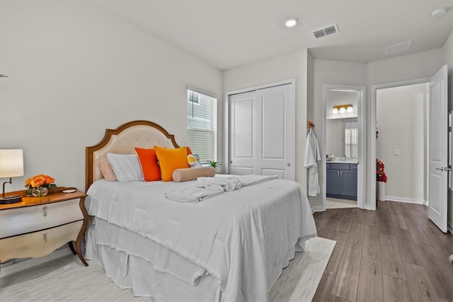3179 Sailing Pier Ave, Winter Garden, FL 34787 - bedroom with wood finished floors, a closet, connected bathroom, and recessed lighting