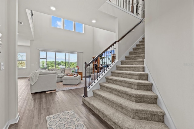 3179 Sailing Pier Ave, Winter Garden, FL 34787 - stairway with a high ceiling, recessed lighting, and wood finished floors