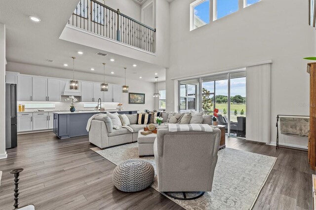 3179 Sailing Pier Ave, Winter Garden, FL 34787 - living room featuring a high ceiling, wood finished floors, and recessed lighting