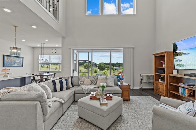 3179 Sailing Pier Ave, Winter Garden, FL 34787 - living room featuring a high ceiling, wood finished floors, a chandelier, and recessed lighting