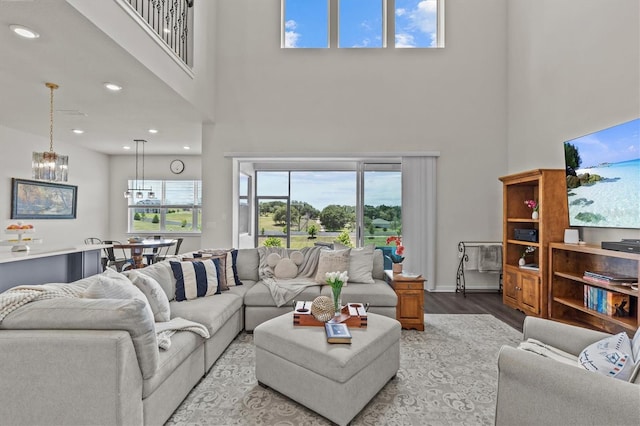 3179 Sailing Pier Ave, Winter Garden, FL 34787 - living area featuring a towering ceiling, wood finished floors, a chandelier, and recessed lighting