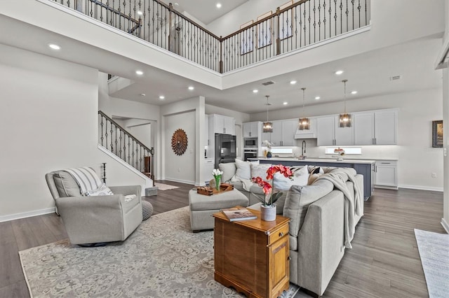 3179 Sailing Pier Ave, Winter Garden, FL 34787 - living room featuring a high ceiling, stairway, dark wood finished floors, and recessed lighting