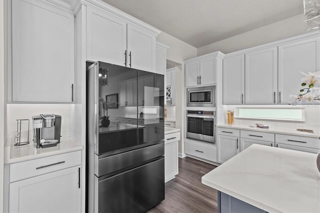3179 Sailing Pier Ave, Winter Garden, FL 34787 - kitchen featuring appliances with stainless steel finishes, white cabinetry, dark wood finished floors, and light countertops