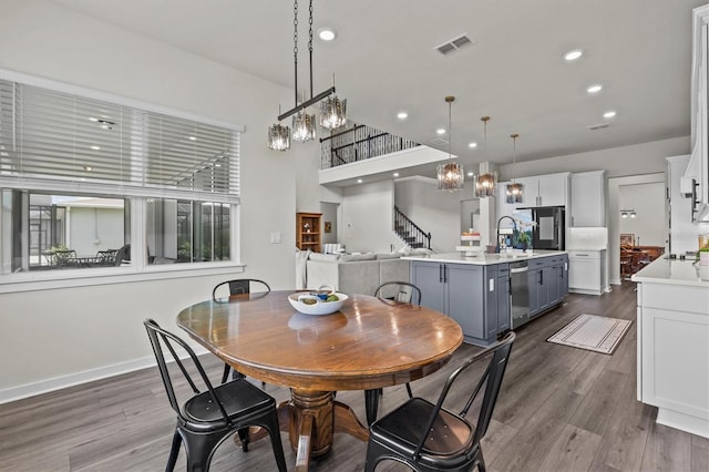3179 Sailing Pier Ave, Winter Garden, FL 34787 - dining area featuring dark wood-type flooring, a chandelier, recessed lighting, and stairway