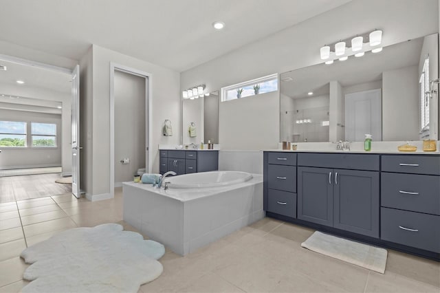 3179 Sailing Pier Ave, Winter Garden, FL 34787 - full bath with a shower stall, a baseboard heating unit, a garden tub, two vanities, and tile patterned flooring