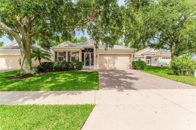 2173 Caledonian St, Clermont, FL 34711 - single story home featuring decorative driveway, a garage, stucco siding, and a front yard