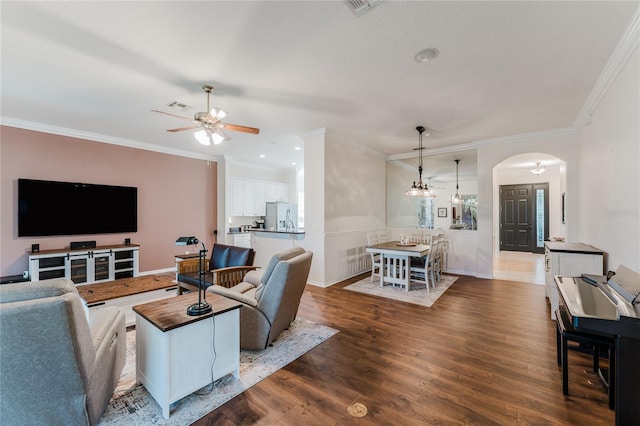 2173 Caledonian St, Clermont, FL 34711 - living room featuring arched walkways, a ceiling fan, dark wood finished floors, crown molding, and recessed lighting