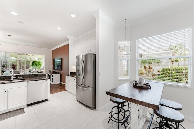 2173 Caledonian St, Clermont, FL 34711 - kitchen featuring stainless steel appliances, ornamental molding, white cabinets, and recessed lighting