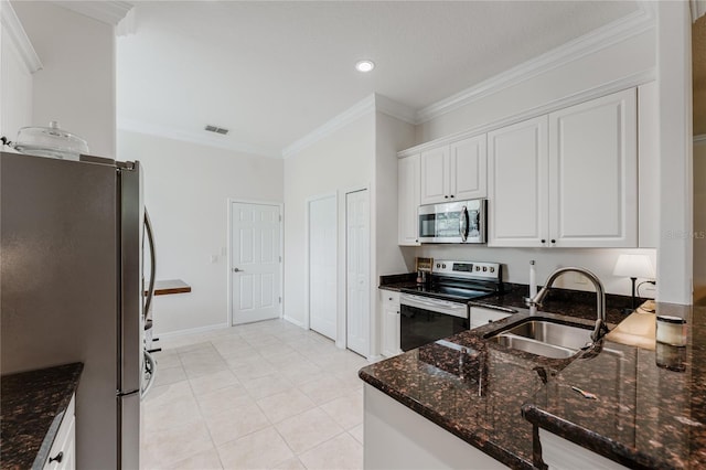 2173 Caledonian St, Clermont, FL 34711 - kitchen featuring stainless steel appliances, white cabinets, ornamental molding, dark stone counters, and recessed lighting