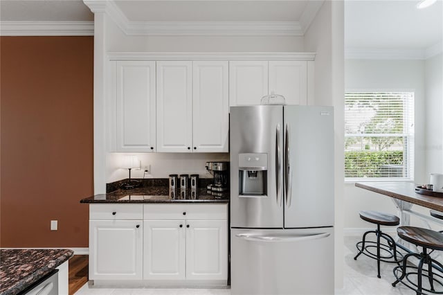 2173 Caledonian St, Clermont, FL 34711 - kitchen featuring stainless steel fridge, white cabinetry, dark stone countertops, and crown molding