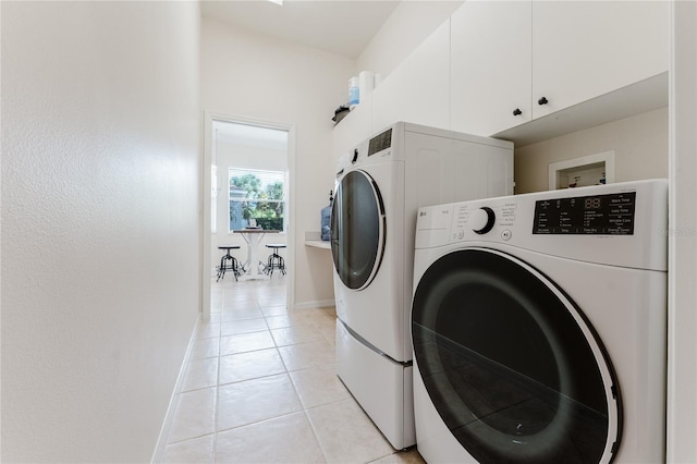 2173 Caledonian St, Clermont, FL 34711 - laundry area with washing machine and clothes dryer, light tile patterned floors, and cabinet space
