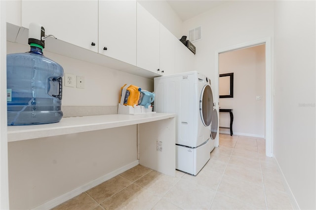 2173 Caledonian St, Clermont, FL 34711 - laundry area with cabinet space, washer / dryer, and light tile patterned floors