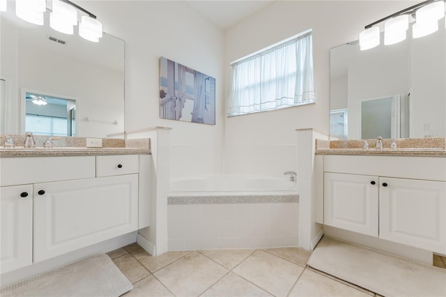 2173 Caledonian St, Clermont, FL 34711 - bathroom featuring a garden tub, healthy amount of natural light, two vanities, and ceiling fan