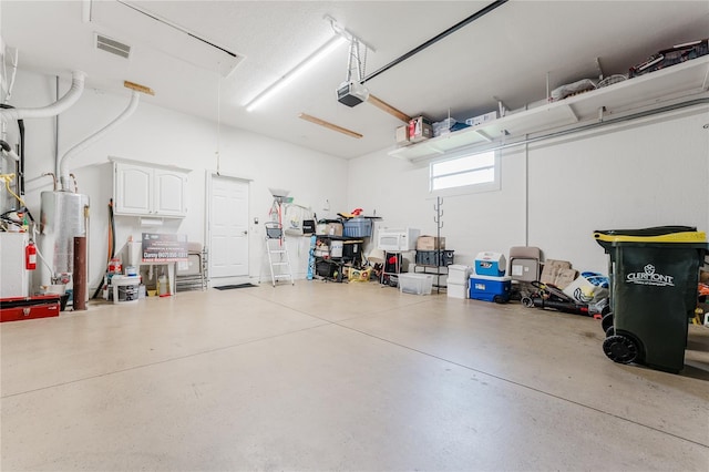 2173 Caledonian St, Clermont, FL 34711 - garage with water heater and a garage door opener