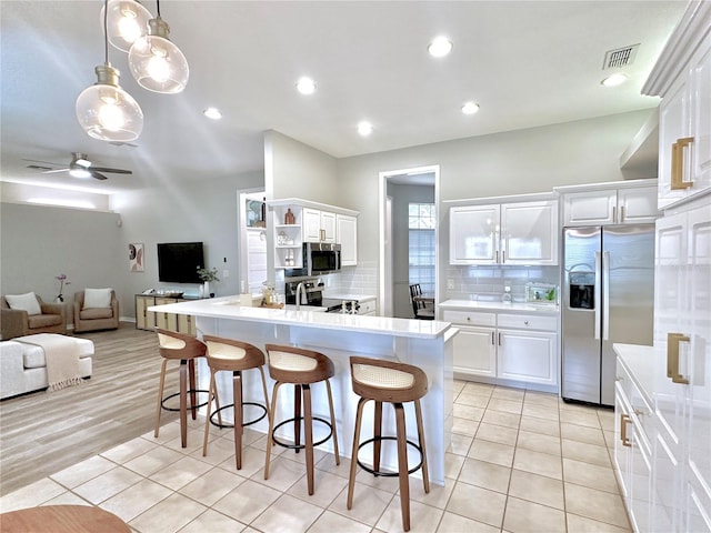5205 Hammock Cir, Saint Cloud, FL 34771 - kitchen with stainless steel appliances, white cabinets, and light countertops